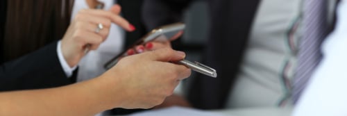 Close up of a woman using her cell phone to provide a signature