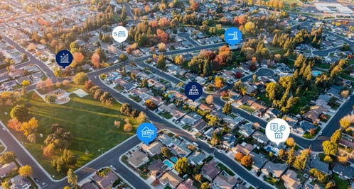 Aerial view at dusk of a suburban neighborhood crisscrossed by gray streets, with 5 colorful overlays illustrating data points about houses for sale.